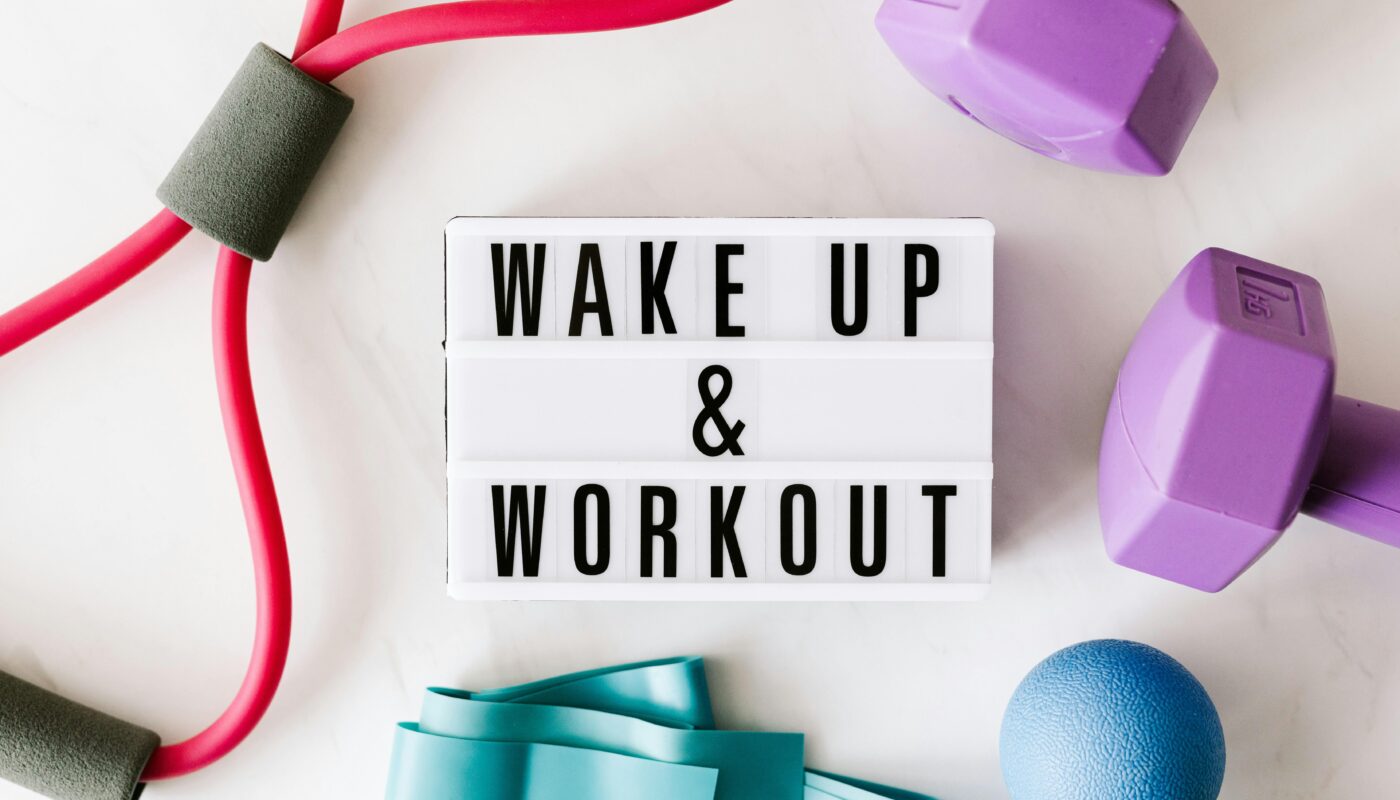 Flat lay of fitness equipment with a motivational slogan for exercise inspiration.
